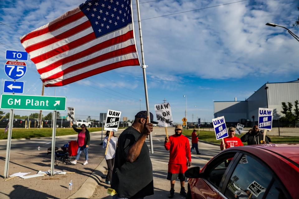 D'Andre Jackson, 43, of Flint walks up to a vehicle trying to enter the General Motors Flint Assembly Plant to ask for an employee ID on the fourth day of the strike