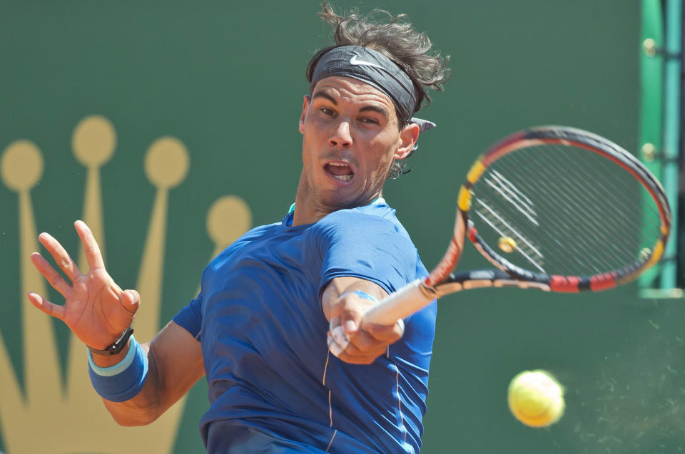 Rafael Nadal of Spain, returns the ball to Andreas Seppi of Italy during their third round match of the Monte Carlo Tennis Masters tournament in Monaco, Thursday, April 17, 2014. Nadal won 6-1 6-3. (AP Photo/Michel Euler)