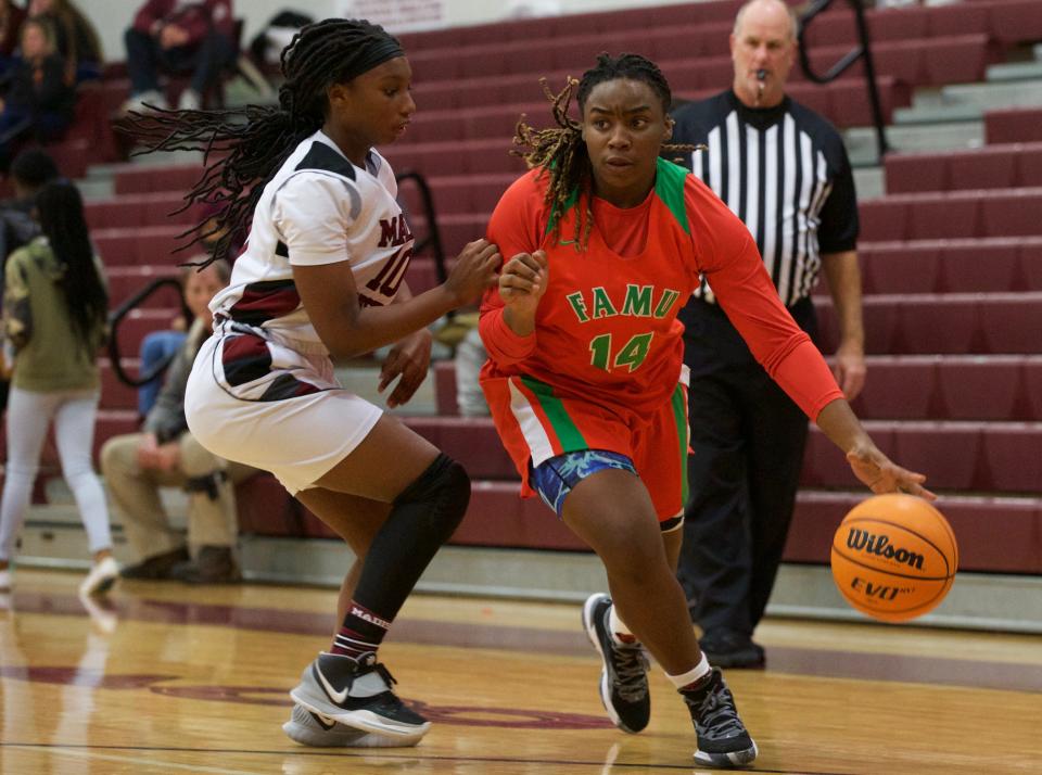 FAMU DRS senior forward Ameari Logan (14) dribbles around a Madison County defender in a game against Madison County on Jan. 22, 2022, at Madison County High School. The Rattlers won 58-31.