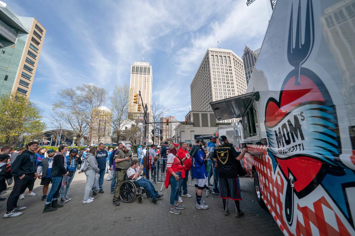 A long line forms for folks to get a taste of Eminem's Mom's Spaghetti near the NFL Draft theater on Friday, April 26, 2024, for the second day of the NFL draft in Detroit.