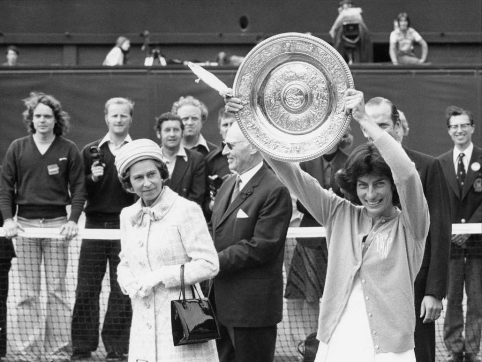 Queen Elizabeth II watches as Virginia Wade holds aloft the Wimbledon Women’s Singles trophy to the crowd on Centre Court on 1 July 1977 (Mike Stephens/Central Press/Hulton Archive/Getty)