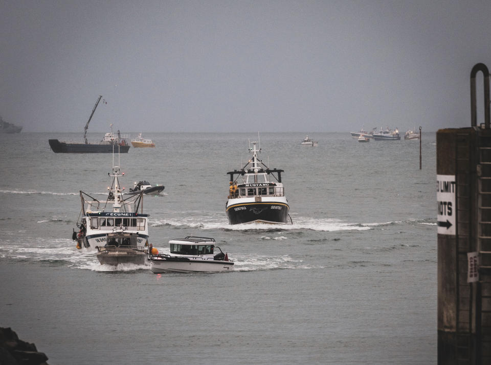 French fishing vessels at sea off the coast of Jersey, Thursday, May 6, 2021. French fishermen angry over loss of access to waters off their coast have gathered their boats in protest off the English Channel island of Jersey. The head of a grouping of Normandy fishermen said about 50 boats from French ports joined the protest Thursday morning and gathered their fleet off the Jersey port of St. Helier. (Oliver Pinel via AP)