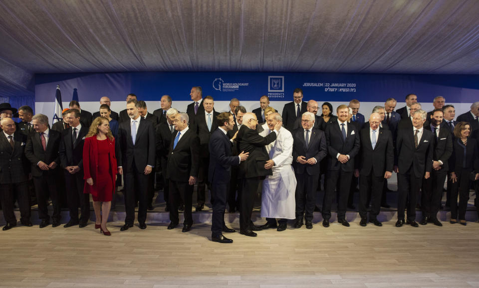 World leaders pose for a group photograph following a dinner reception as Israel's President Reuven Rivlin, center, thanks his chef at his official residence in Jerusalem on Wednesday, Jan. 22, 2020. Dozens of world leaders descended upon Jerusalem Thursday for the largest-ever gathering focused on commemorating the Holocaust and combating modern-day anti-Semitism. (Heidi Levine/Pool photo via AP)