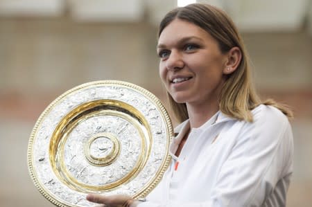 Simona Halep, who became the first Romanian to win a Wimbledon shows her trophy at the airport in Bucharest