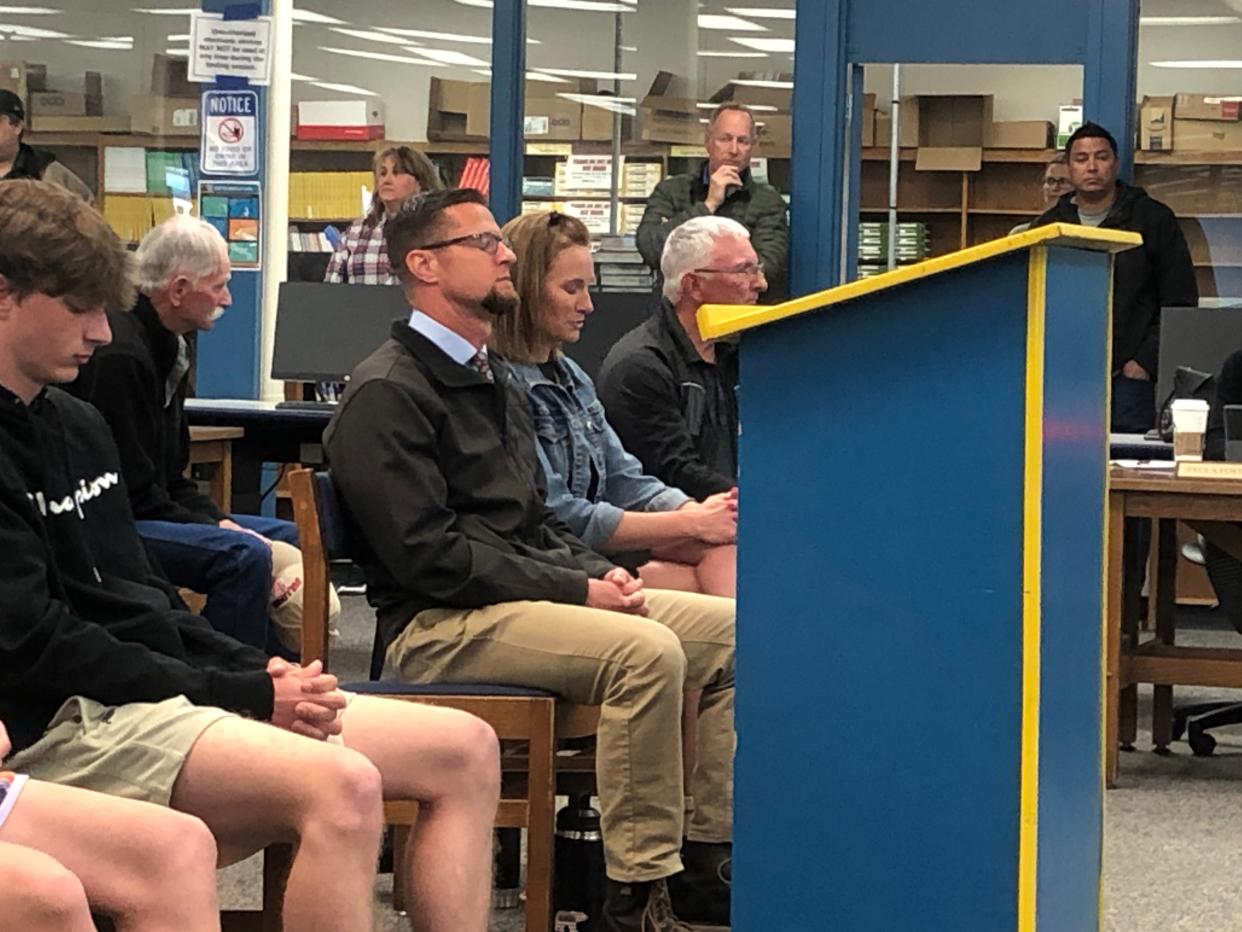 Former Anderson High School principal Thomas Safford (center) sits in on discussions during the Anderson Union High School District board meeting next his wife Carrie Safford on Tuesday, April 18, 2023.