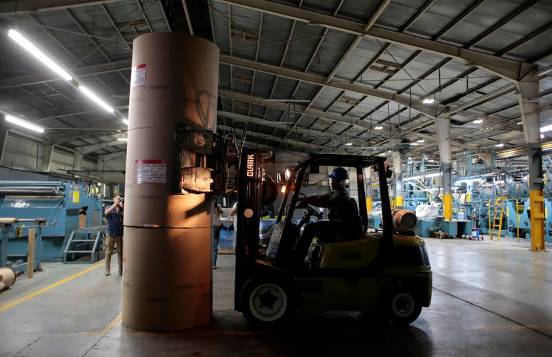 A fork lifttruck driver moves paper rolls in the La Prensa newspaper printing plant in Managua