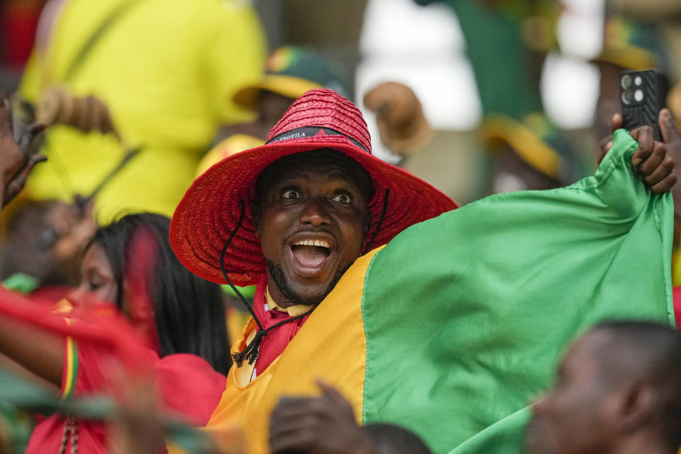 Guinea fans cheer before the start of the African Cup of Nations Round of 16 soccer match between Equatorial Guinea and Guinea, at the Olympic Stadium of Ebimpe in Abidjan, Ivory Coast, Sunday, Jan. 28, 2024. (AP Photo/Themba Hadebe)