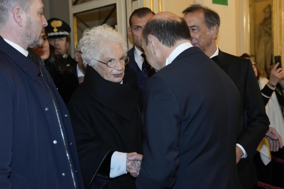 Italian Senator Liliana Segre, left, is greeted by La Scala CEO and Artistic Director Dominique Meyer as she arrives to attend La Scala opera house's gala season opener, Giuseppe Verdi's opera 'Don Carlo' at the Milan La Scala theater, Italy, Thursday Dec. 7, 2023. The season-opener Thursday, held each year on the Milan feast day St. Ambrose, is considered one of the highlights of the European cultural calendar. (AP Photo/Luca Bruno)