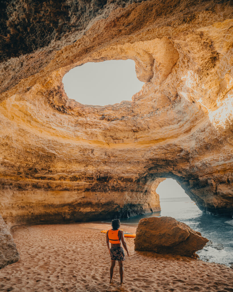 A person standing inside Benagil Cave