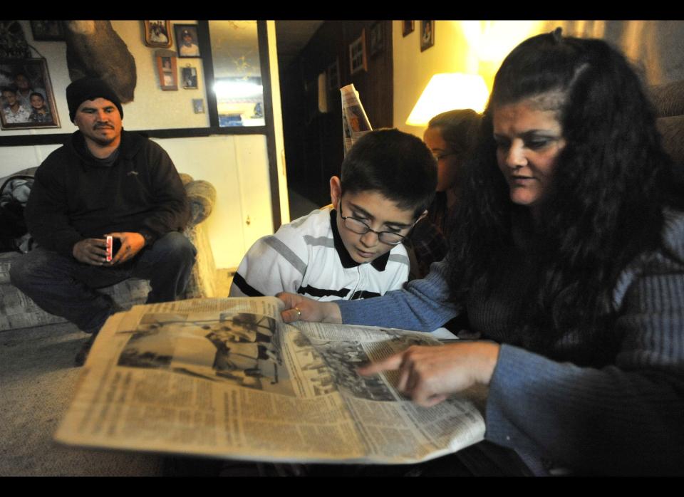 FILE - TO GO WITH INMIGRANTE DETENCION - In this Dec. 17, 2011 file photo, Tara Ammons Cohen reads with her son, Gavin, about a family friend in the local newspaper. Ammons Cohen was arrested in October 2008 on a drug charge and spent nearly three years locked up at the federal immigration detention center in Tacoma. She can