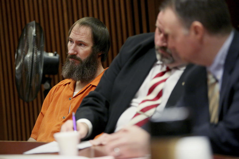 Johnny Bobbitt sits with his attorneys, John Keesler, center, and Stephen P. Hunter, right, during his sentencing hearing at Burlington County Superior Court in Mount Holly, N.J., Friday, April 12, 2019. Bobbitt, the homeless veteran who admitted to conspiring with a New Jersey couple in a GoFundMe scam that raised more than $400,000, was sentenced Friday to five years' probation. (Tim Tai/The Philadelphia Inquirer via AP, Pool)