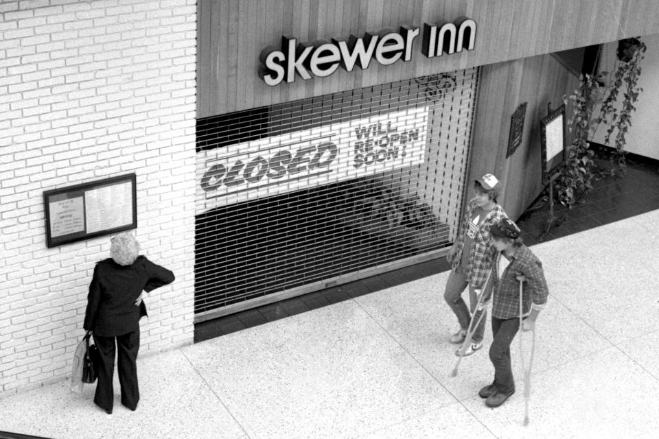 In this Journal Star file photo from Oct. 17, 1983, Northwoods Mall patrons pass by the shuttered Skewer Inn after its closing due to a severe botulism outbreak.