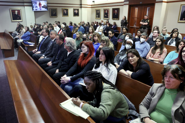 Spectators listen in the courtroom at the Fairfax County Circuit Court in Fairfax, Va., Thursday, April 28, 2022. Depp sued his ex-wife actor Amber Heard for libel in Fairfax County Circuit Court after she wrote an op-ed piece in The Washington Post in 2018 referring to herself as a "public figure representing domestic abuse." (Michael Reynolds/Pool Photo via AP)