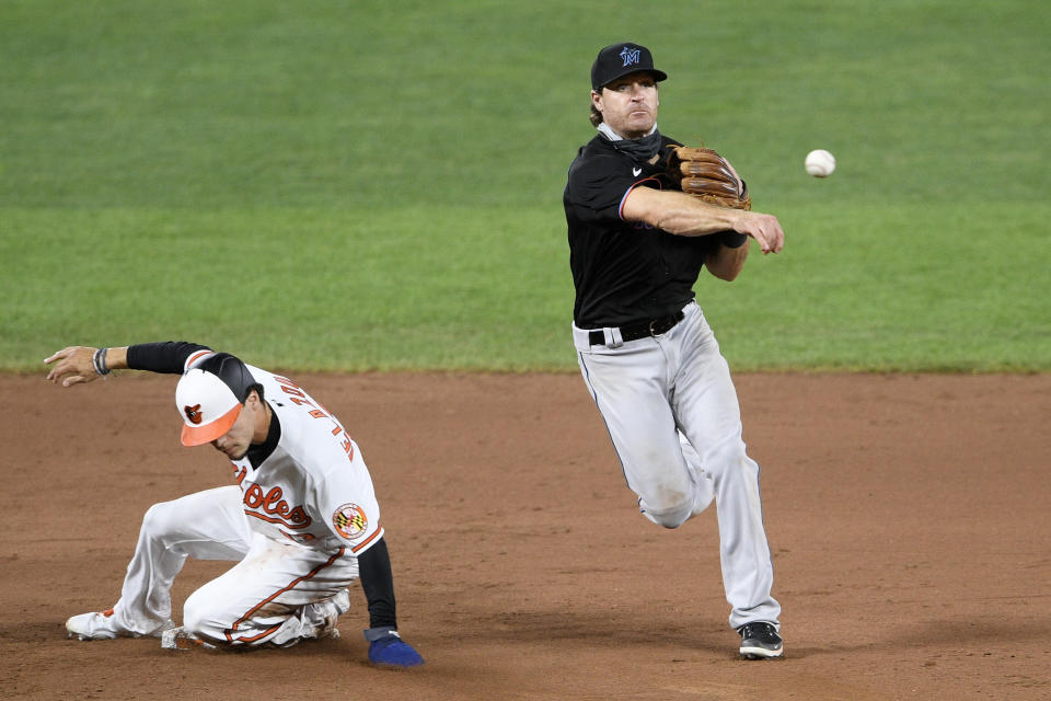 Baltimore Orioles' Andrew Velazquez, left, is out at second as Miami Marlins second baseman Logan Forsythe, right, throws to first to get out Orioles' Hanser Alberto to complete a double play during the ninth inning of a baseball game, Thursday, Aug. 6, 2020, in Baltimore. (AP Photo/Nick Wass)