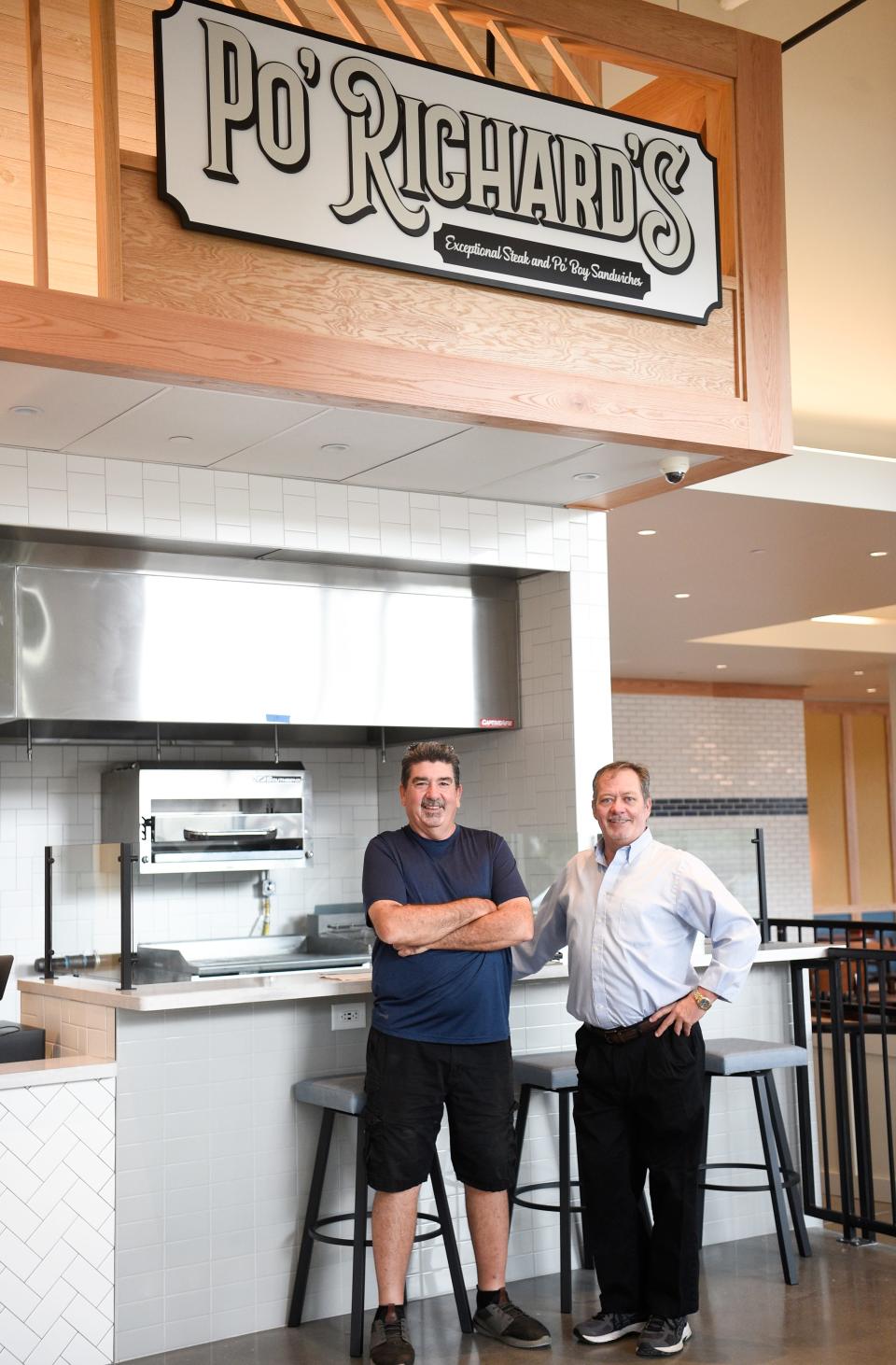 Po’ Richard’s Rick Simek and Donnie Rudder pose for a photo in front of their new location in the Marble City Market Friday, Oct. 22, 2021.