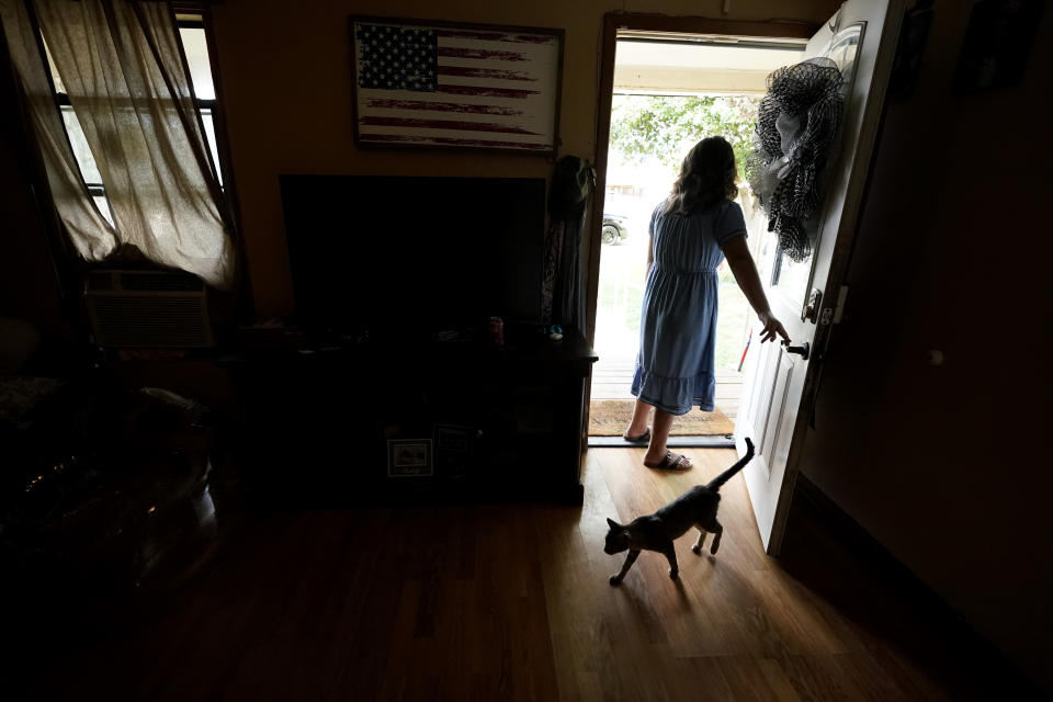 Nana, a student who survived the school shootings at Robb Elementary stands in the doorway of her home, Monday, July 11, 2022, in Uvalde, Texas. Students who survived the May 24 shooting at an elementary school in Uvalde, Texas are spending the summer grappling with post-traumatic stress disorder. Meanwhile, parents find themselves unable to help them, worried the tragedy at Robb Elementary struck a largely Hispanic town as Latinos continue to face disparities to access mental health care. (AP Photo/Eric Gay)