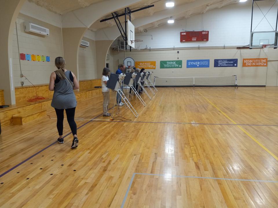 A voter steps up to cast her vote at Thames Elementary School, the precinct for Ward 3 in Hattiesburg, Miss., during municipal elections Tuesday, June 8, 2021.