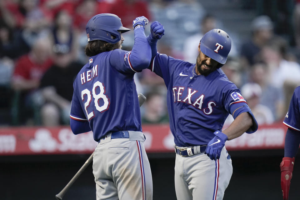 Texas Rangers' Marcus Semien, right, celebrates his three-run home run with Jonah Heim during the fourth inning of a baseball game against the Los Angeles Angels, Saturday, July 30, 2022, in Anaheim, Calif. (AP Photo/Jae C. Hong)