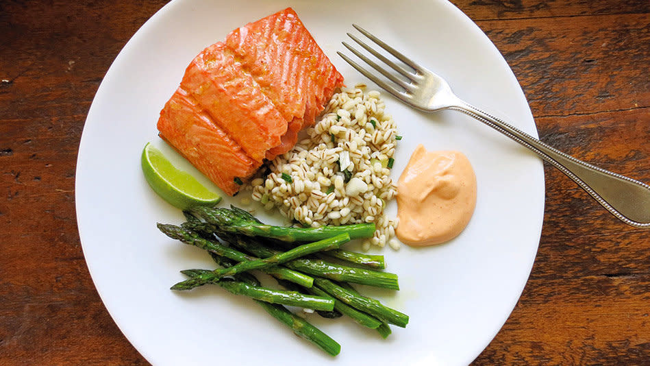 Here's a baked-fish-and-veggies dish with a deep, rich flavor from surprisingly few ingredients. While the salmon (or other flaky, oil-rich fish) cooks in an olive-oil-lemon-juice-honey glaze, you stir together a ridiculously simple sriracha mayo to accompany it. The fish is delicious on its own, with a sweetness reminiscent of teriyaki but none of the salty soy-sauce flavor. With the spiced mayo, it's out of this world. (And if you don't feel like buying the chives the recipe calls for, you can use a tiny bit of minced shallot, which pops up in a few other recipes here.) <br /><br /><strong>Get the recipe: <a href="http://www.oprah.com/food/Roasted-Salmon-and-Asparagus-with-Spicy-Mayo-and-Chives-Recipe" target="_blank">Roasted Salmon and Asparagus with Spicy Mayo and Chives</a></strong>