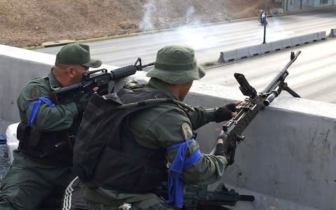 Rebelling forces identified themselves with blue armbands - Credit: Yuri Cortez/AFP