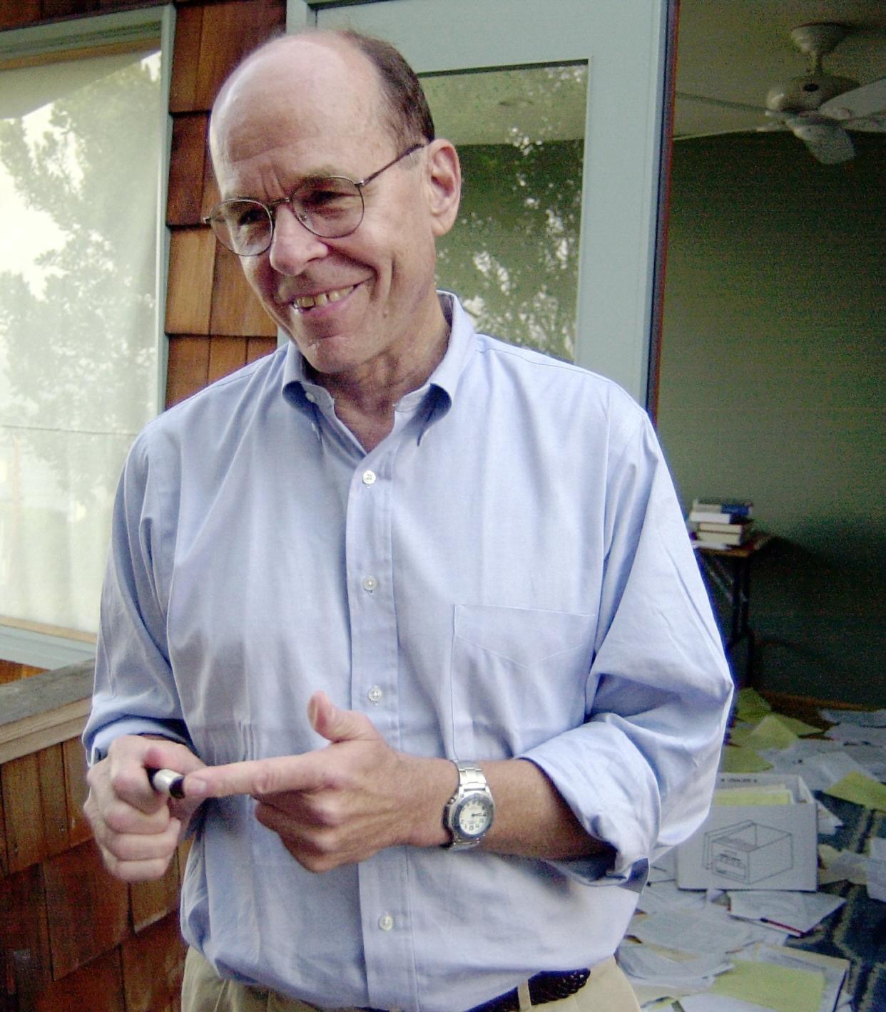 FILE - K. Barry Sharpless points to a sample used in his work, as he stands on the balcony outside of his home office in La Jolla, Calif. on Oct. 10, 2001. This year’s Nobel Prize in chemistry has been awarded in equal parts to Carolyn R. Bertozzi, Morten Meldal and K. Barry Sharpless for developing way of “snapping molecules together.” (AP Photo/Denis Poroy)