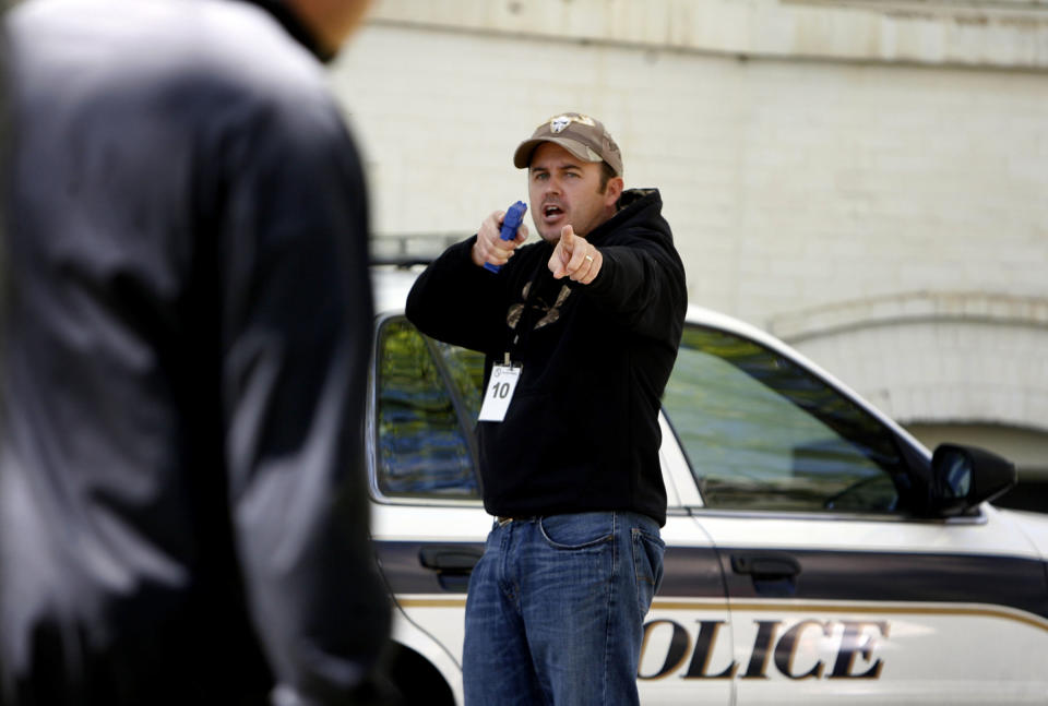 This 2004 file photo shows Utah County Sheriff's Sgt. Cory Wride, in a training exercise in Provo, Utah. A man with a rifle shot and killed Wride along a highway Thursday, Jan. 30, 2014, and wounded another deputy during a chase that stretched over 50 miles before he was caught, Utah County Sheriff Jim Tracy said. Wride had pulled up to a car that appeared disabled near Eagle Mountain when he was ambushed around 1 p.m. Thursday, the sheriff said. Eagle Mountain is a town about 35 miles south of Salt Lake City. (AP Photo/The Deseret News, Laura Seitz) SALT LAKE TRIBUNE OUT; MAGS OUT