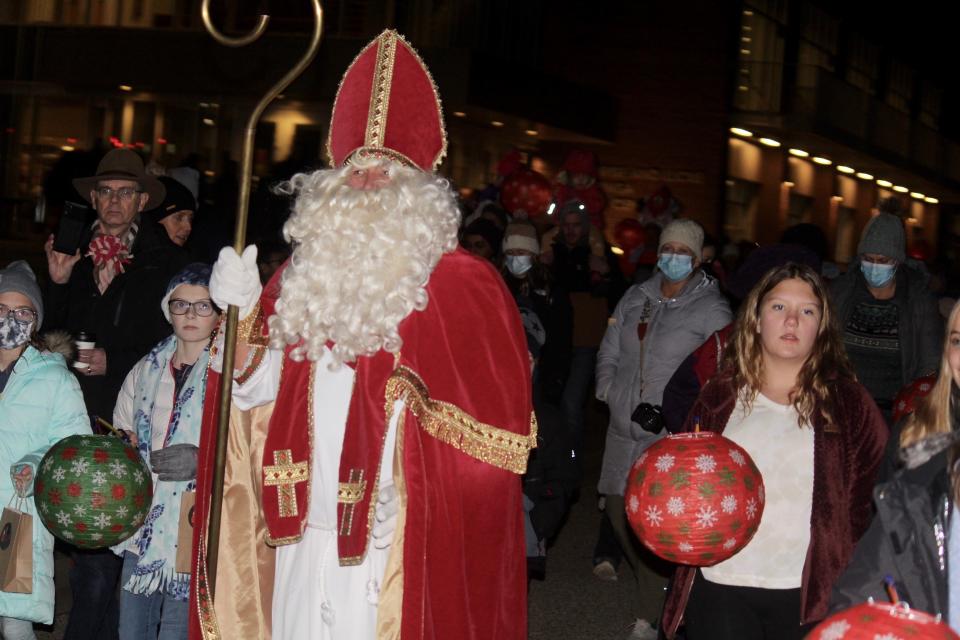 Sinterklaas leads a parade of children in song through the downtown Kerstmarkt on Friday, Dec. 3, 2021, in Holland, Mich.