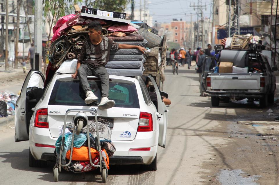 A person sits atop a vehicle loaded with belongings as they leave Rafah after Israel drops evacuation notices (REUTERS)