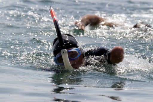 Phillipe Croizon swims across the Red Sea from Egypt's Taba to Aqaba in Jordan in June. He is instantly recognisable from a distance by the windmill movements of the front crawl stroke that he makes with the remainder of his upper arms