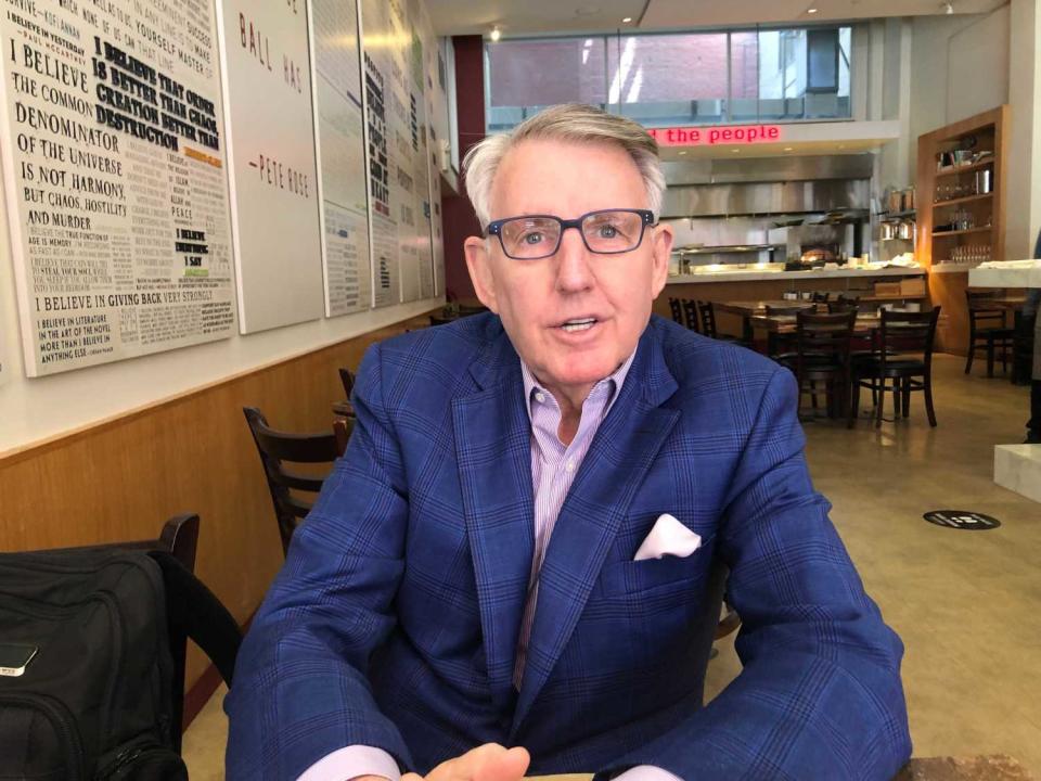 A closeup of Clint Reilly sitting at a restaurant table.