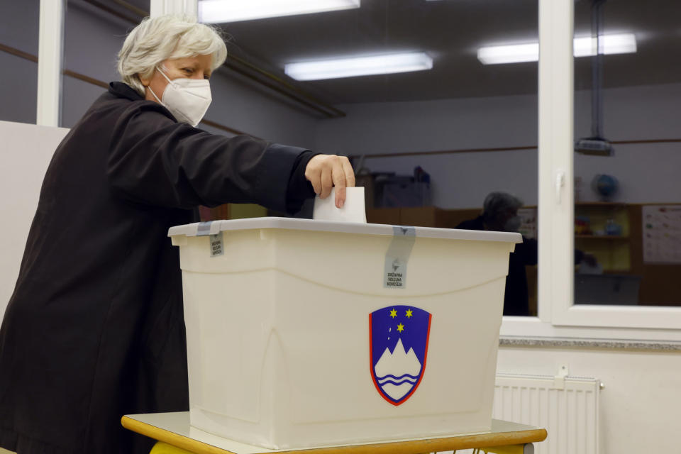 A woman casts her ballot for a presidential election at a poling station in Ljubljana, Slovenia, Sunday, Oct. 23, 2022. Voters in Slovenia on Sunday cast ballots to elect a new president of the European Union nation, with three main contenders leading the race but no clear winner in sight. (AP Photo)