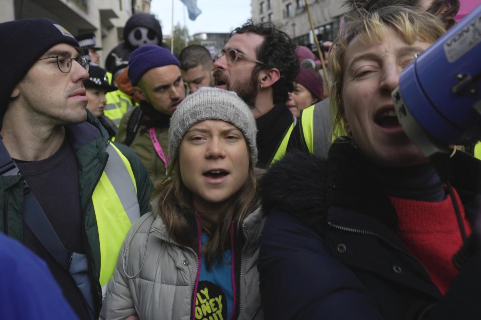 Environmental activist Greta Thunberg shouts slogans during the Oily Money Out protest outside the Intercontinental Hotel, in London, Tuesday, Oct. 17, 2023. (AP Photo/Kin Cheung)