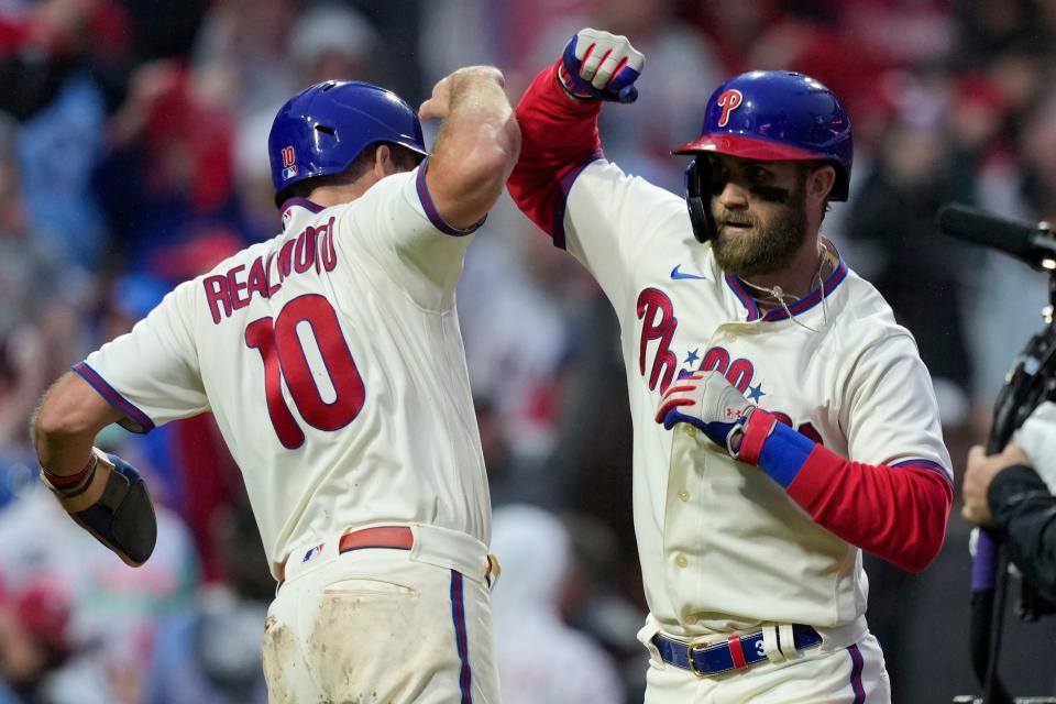 Bryce Harper celebrates after a two-run home run with J.T. Realmuto in the eighth inning of Game 5.