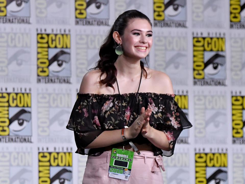 Nicole in front of a Comic-Con backdrop.