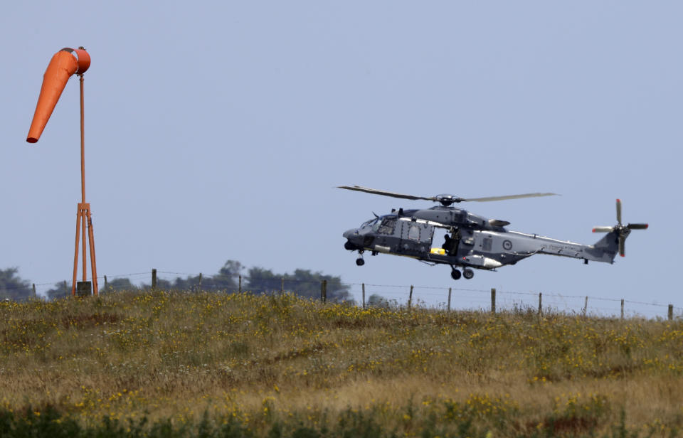 A Navy helicopter returns to Whakatane Airport following the recovery operation to return the victims of the Dec. 9 volcano eruption continues off the coast of Whakatane New Zealand, Friday, Dec. 13, 2019. A team of eight New Zealand military specialists landed on White Island early Friday to retrieve the bodies of victims after the Dec. 9 eruption. (AP Photo/Mark Baker)