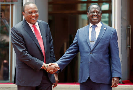 FILE PHOTO: Kenya's President Uhuru Kenyatta (L) greets opposition leader Raila Odinga of the National Super Alliance (NASA) coalition after addressing a news conference at the Harambee house office in Nairobi, Kenya March 9, 2018. REUTERS/Thomas Mukoya/File Photo