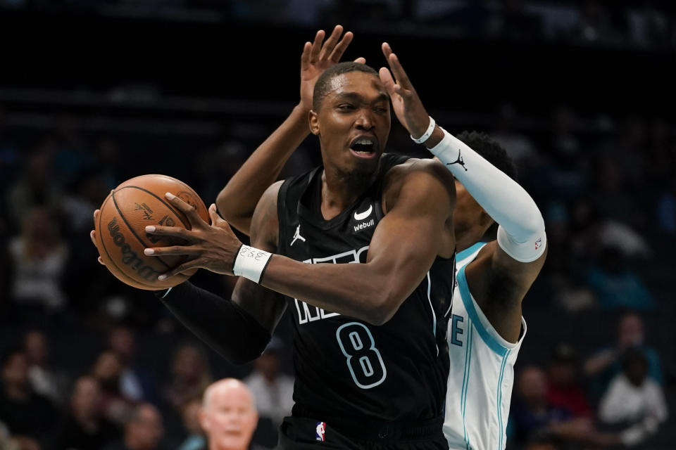 Charlotte Hornets forward Brandon Miller, back, defends against Brooklyn Nets guard Lonnie Walker IV in the first half of an NBA basketball game, Monday, Oct. 30, 2023, in Charlotte, N.C. (AP Photo/Erik Verduzco)