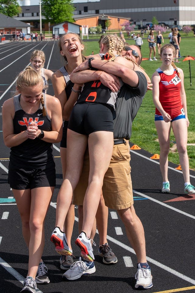 Winnebago head coach Joe Erb hugs one of his relay runners, and daughters, Grace Erb, after the team set a school record and the state's fastest time in the 1,600-meter relay in Winnebago on Saturday, May 14, 2022.