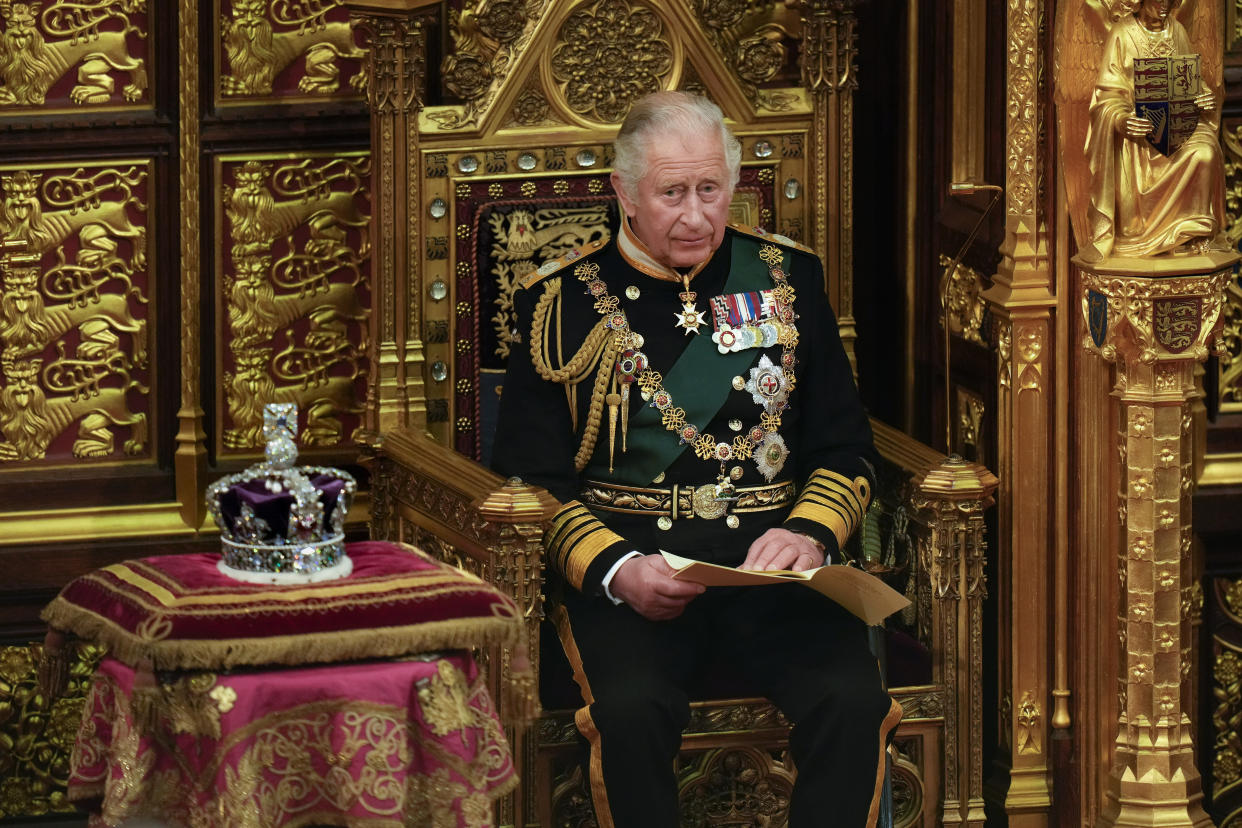 LONDON, ENGLAND - MAY 10: Prince Charles, Prince of Wales reads the Queen's speech next to her Imperial State Crown in the House of Lords Chamber, during the State Opening of Parliament in the House of Lords at the Palace of Westminster on May 10, 2022 in London, England. The State Opening of Parliament formally marks the beginning of the new session of Parliament. It includes Queen's Speech, prepared for her to read from the throne, by her government outlining its plans for new laws being brought forward in the coming parliamentary year. This year the speech will be read by the Prince of Wales as HM The Queen will miss the event due to ongoing mobility issues. (Photo by Alastair Grant - WPA Pool/Getty Images)