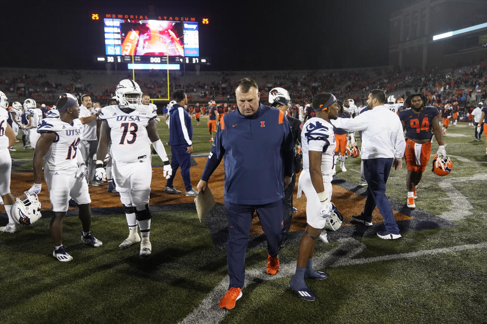 Illinois head coach Bret Bielema, center, walks off the field after his team's loss to UTSA in an NCAA college football game Saturday, Sept. 4, 2021, in Champaign, Ill. (AP Photo/Charles Rex Arbogast)