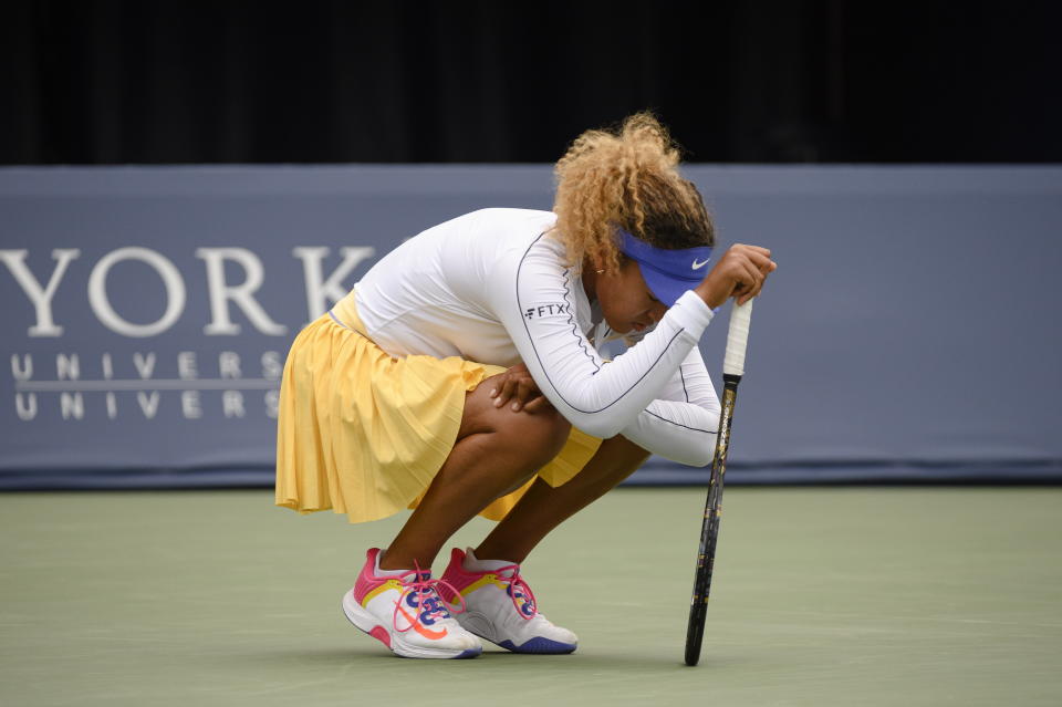 Naomi Osaka rests during a match against Kaia Kanepi of Estonia, during the National Bank Open tennis tournament in Toronto, on Tuesday, Aug. 9, 2022. (Christopher Katsarov/The Canadian Press via AP)