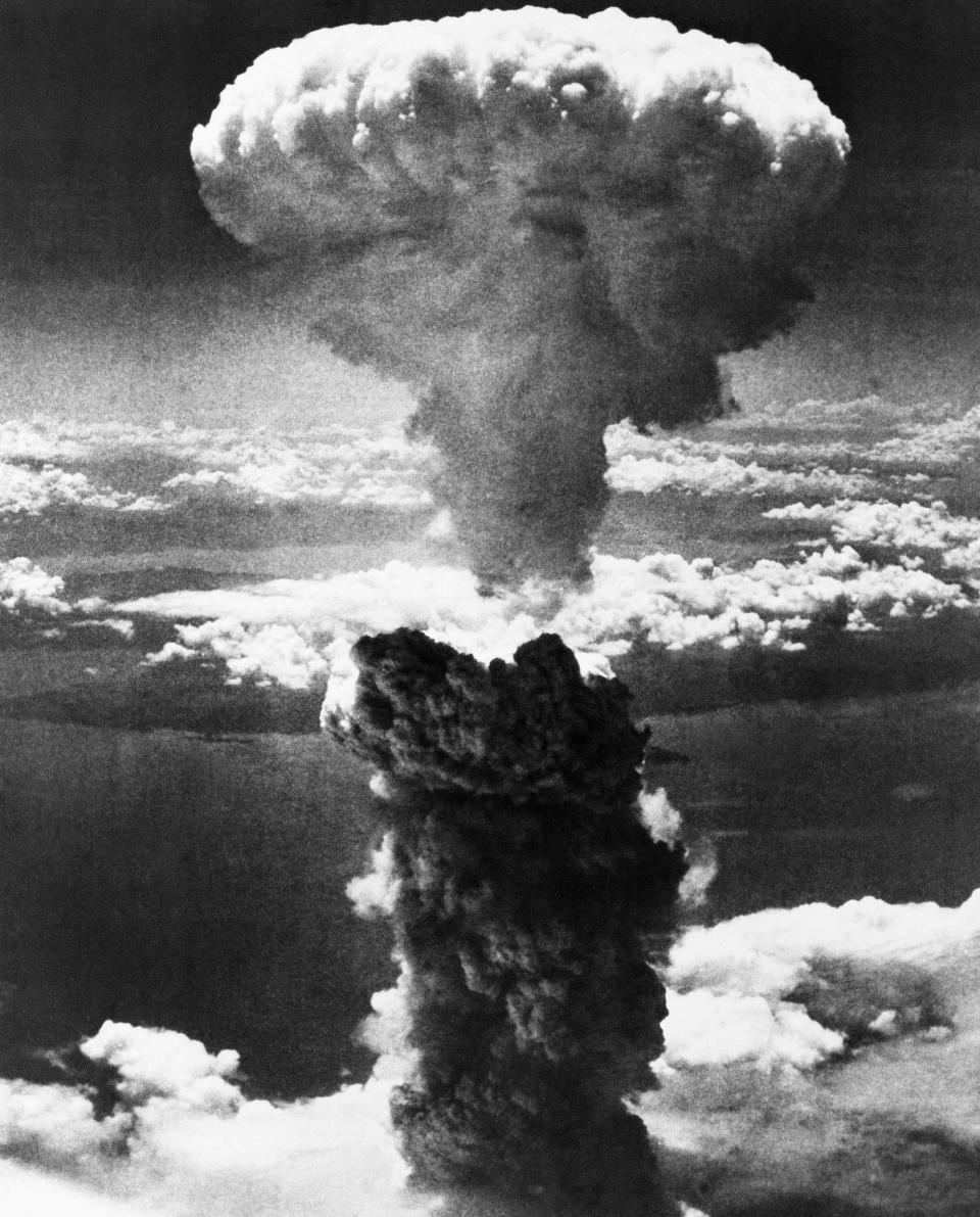 FILE - In this Aug. 9, 1945, file photo, a giant column of smoke rises after the second atomic bomb ever used in warfare explodes over the Japanese port town of Nagasaki. The city of Nagasaki in southern Japan marks the 75th anniversary of the U.S. atomic bombing of Aug. 9, 1945. Japan surrendered on Aug. 15, ending World War II and its nearly a half-century aggression toward Asian neighbors. Dwindling survivors, whose average age exceeds 83, increasingly worry about passing their lessons on to younger generations. (AP Photo, File)