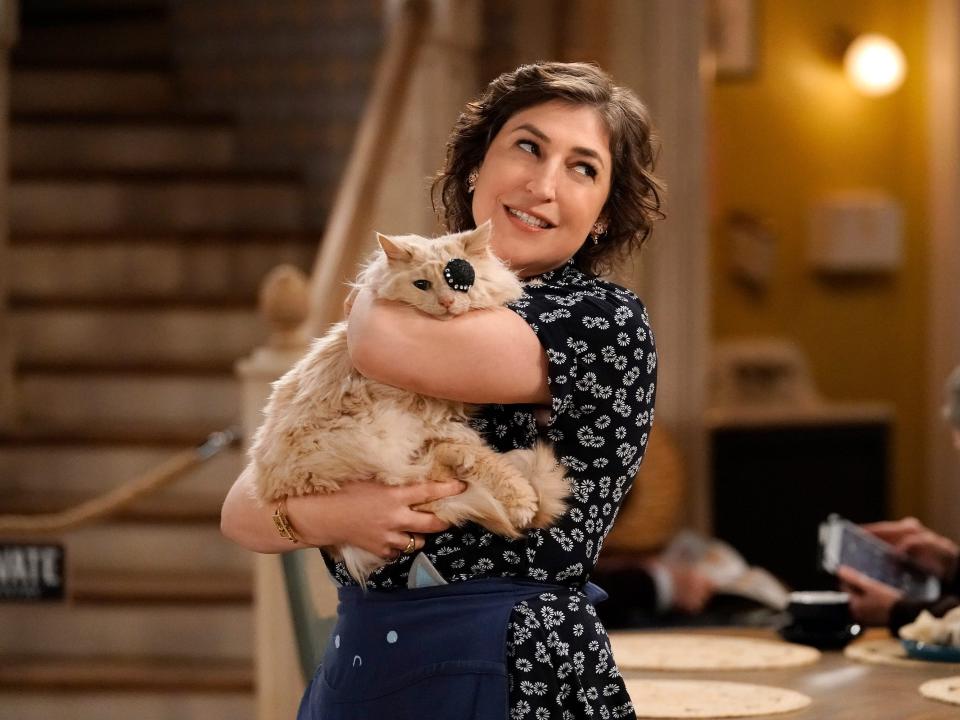 Mayim Bialik in "Call Me Kat." She holds a cat wearing an eye patch.