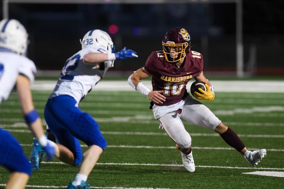 Harrisburg's wide receiver Max Carlson (10) evades O'Gorman's line backer Krayton Raasch (32) on Friday, Nov. 3, 2023 at Harrisburg High School in Harrisburg, South Dakota.