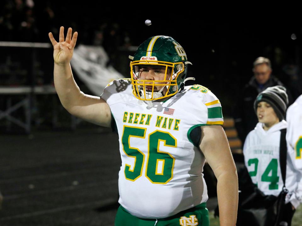 Newark Catholic's Mark Jewett signals the fourth quarter during a Division VII state semifinal loss to Warren JFK last season.