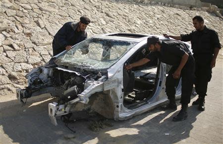 Hamas naval police inspect parts of a car which they said was seized from two Palestinians who tried to smuggle it from Egypt by sea into Gaza City November 11, 2013. REUTERS/Mohammed Salem