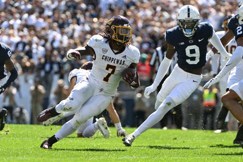 Central Michigan running back Lew Nichols III (7) runs away from Penn State cornerback Joey Porter Jr. (9) during the first half of an NCAA college football game, Saturday, Sept. 24, 2022, in State College, Pa. (AP Photo/Barry Reeger)