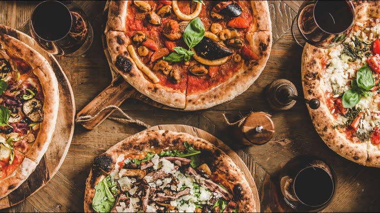 Four pizzas on table