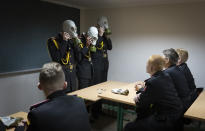 Cadets practice an emergency situation during a lesson in a bomb shelter on the first day of school at a cadet lyceum in Kyiv, Ukraine, Thursday, Sept. 1, 2022. (AP Photo/Efrem Lukatsky)