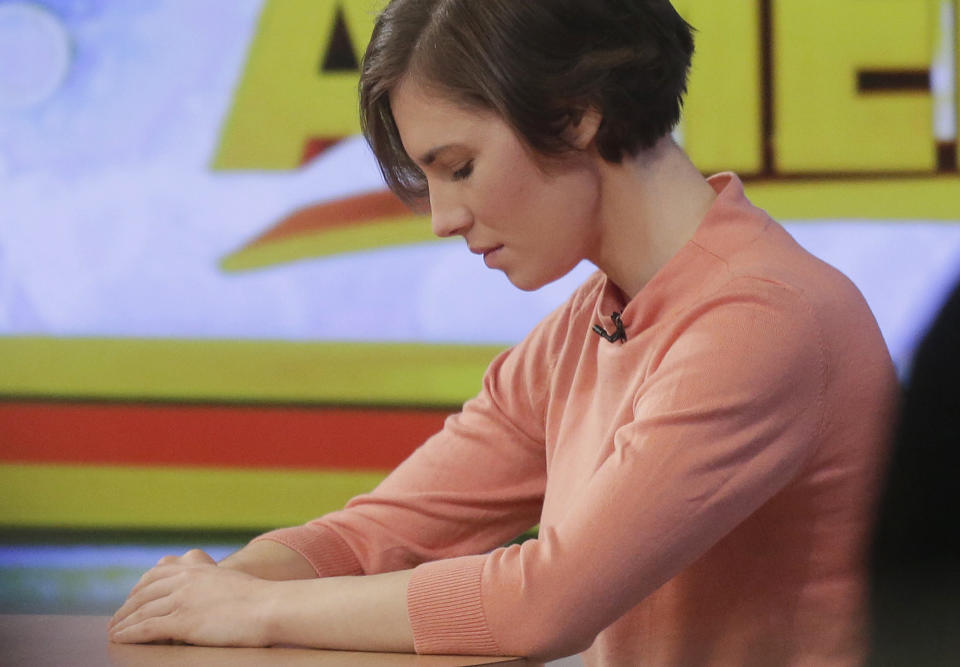 Amanda Knox bows her head during a television interview, Friday, Jan. 31, 2014 in New York. Knox said she will fight the reinstated guilty verdict against her and an ex-boyfriend in the 2007 slaying of a British roommate in Italy and vowed to "never go willingly" to face her fate in that country's judicial system . "I'm going to fight this to the very end," she said in an interview with Robin Roberts on ABC's "Good Morning America." (AP Photo/Mark Lennihan)